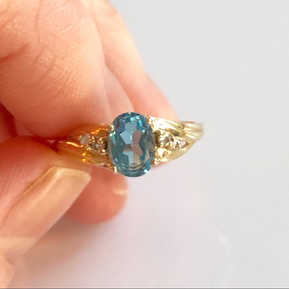 Blue Topaz 10k gold ring with 4 cz